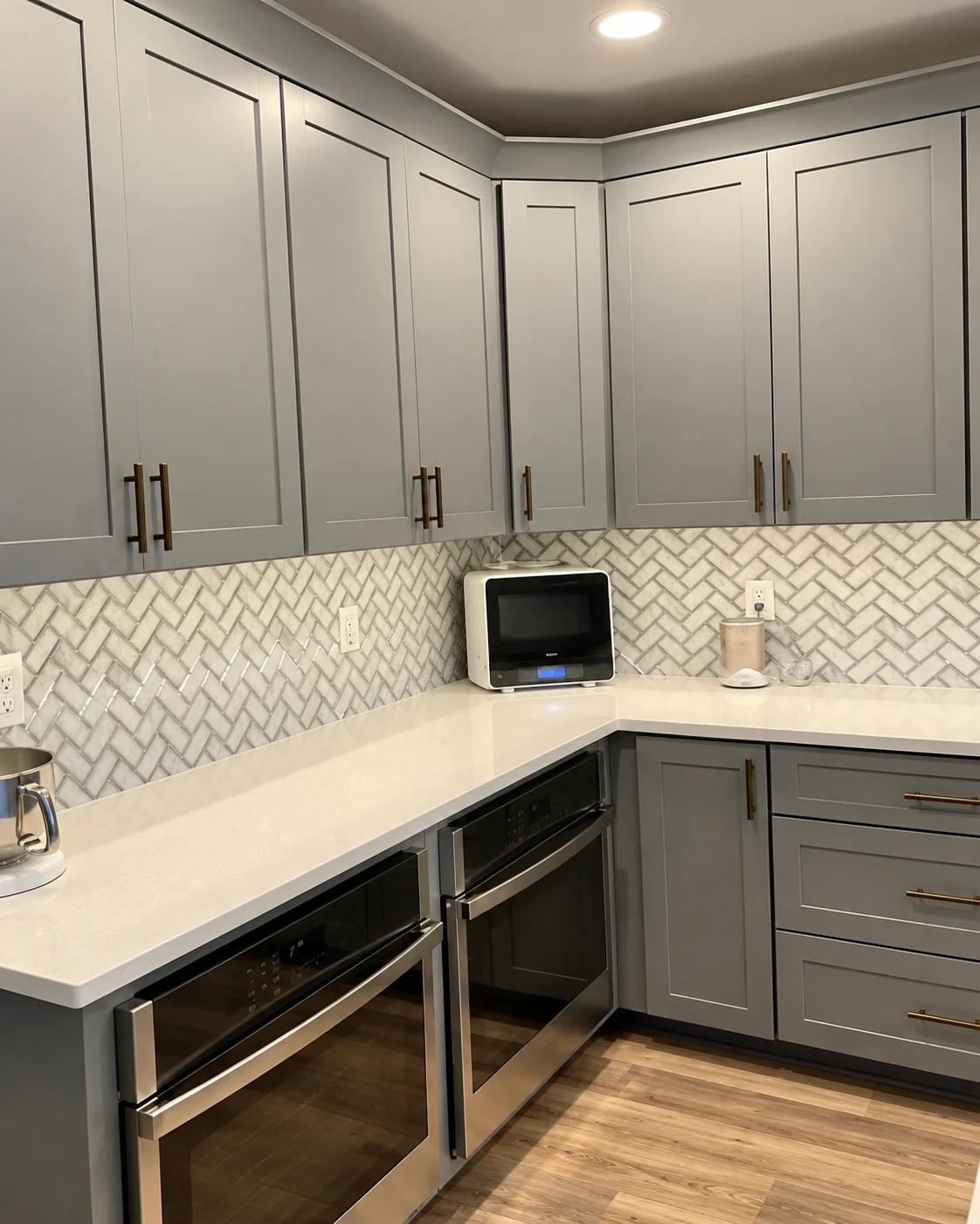Gray kitchen cabinetry with brass handles